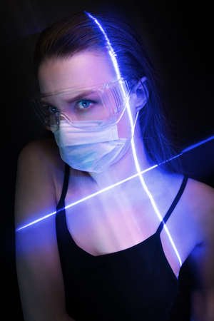 Girl in protective glasses and mask undergoes scanの写真素材