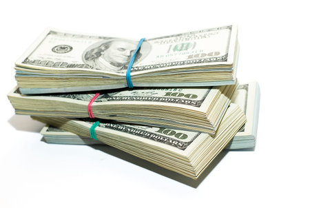 Four packs of US dollars banknotes on a white background
