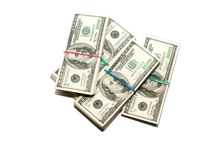 Four packs of US dollars banknotes on a white background