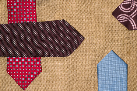 Four beautiful colored ties on the old sackingの写真素材