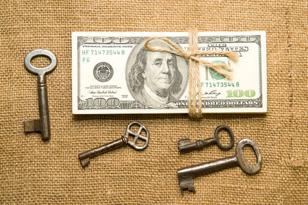 One pack of dollars tied up with rope in the old clothの写真素材