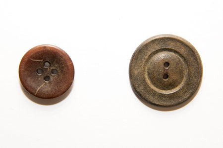 Two big old buttons  on white backgroundの写真素材