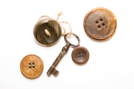 A lot button, Old key with affection for him a vintage button on a white backgroundの写真素材