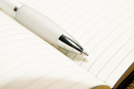 notebook with a blank sheet and pen on the old tissueの写真素材