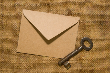 Vintage key and envelope for letters on the old clothの写真素材