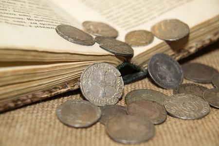 A lot of old French silver coins with portraits of kings on the old clothの写真素材