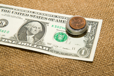 Dollars banknote and coins on an old cloth