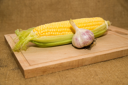 A ripe fruit of corn on a wooden surfaceの写真素材