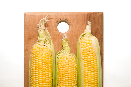 A ripe fruits of corn on a wooden surfaceの写真素材