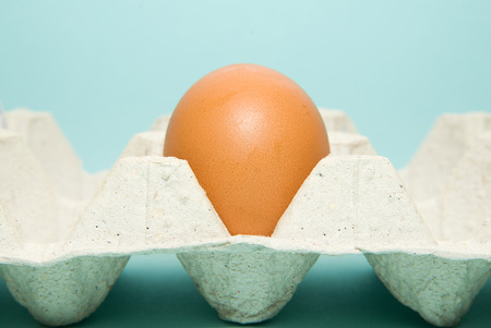 Chicken egg in the package on over blueの写真素材
