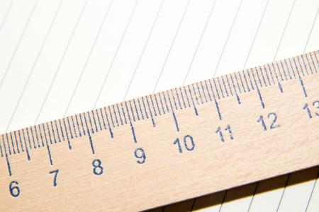 Notepad with a recording sheet and wooden ruler on the old tissueの写真素材