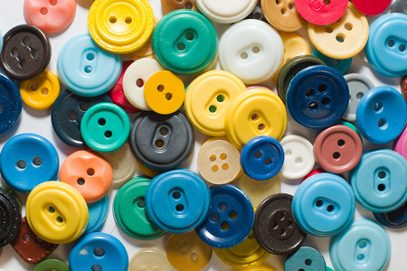 A lot of old buttons  on a white backgroundの写真素材