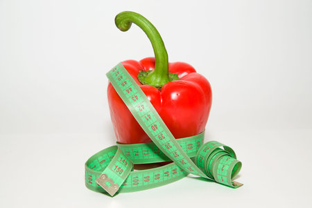 Ripe red pepper and of tailoring meter on over white