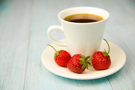 Cup and strawberry on over blueの写真素材