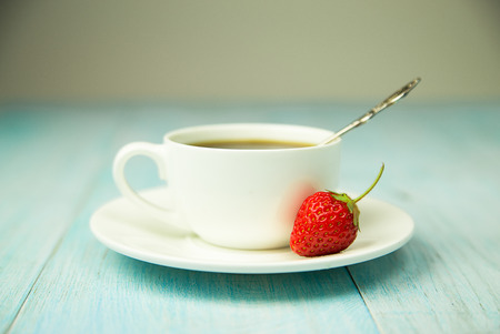 Cup and strawberry on over blueの写真素材