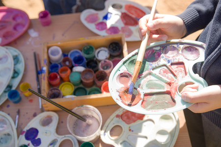 Jars with gouache paints are on the tableの写真素材