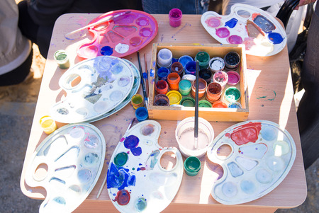 Jars with gouache paints are on the tableの写真素材