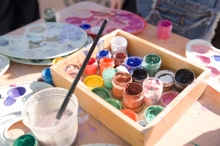 Jars with gouache paints are on the tableの写真素材