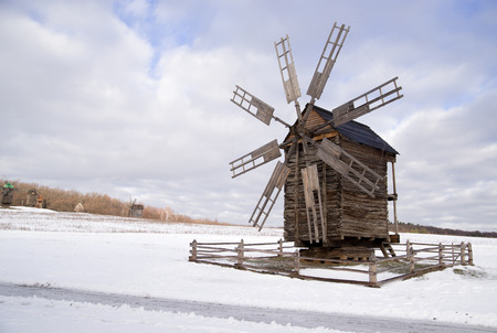 Windmill against a blue sky with cloudsの写真素材