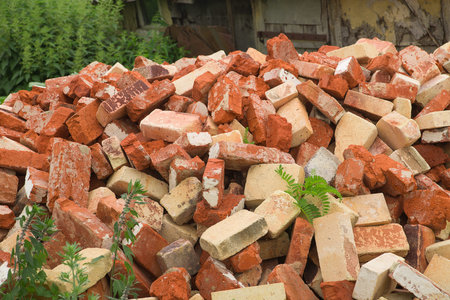 A lot of used bricks is lying big pile