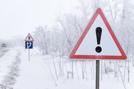The road sign is on the snowy sideの写真素材