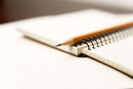 Pencil on the pages of an open notebookの写真素材