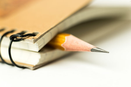 Pencil on the pages of an closed notebookの写真素材