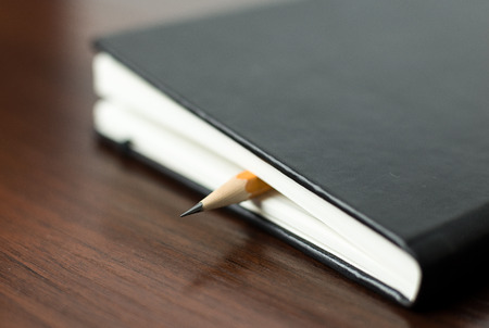 Pencil on the pages of an closed notebookの写真素材