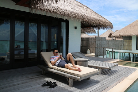 Closeup of a man lying on the chairのeditorial素材
