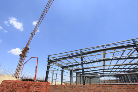 The steel structure under the blue sky white cloudsの写真素材