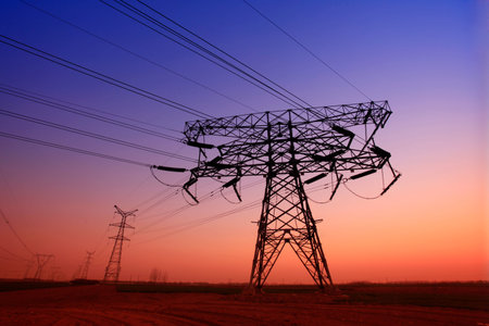 The high voltage towers silhouette of the evening
