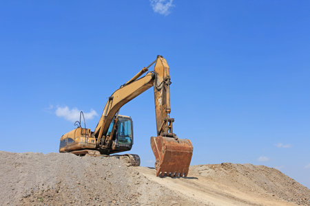 An old excavator, work under the blue sky