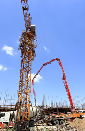 Construction site under the blue sky white clouds, the workers are workingの写真素材