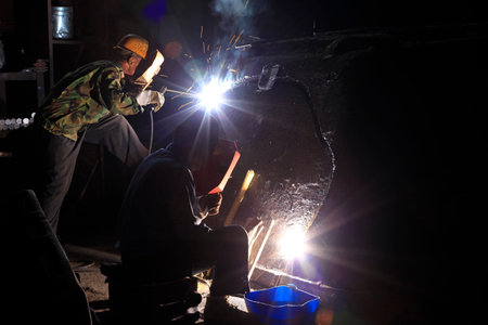 In the steel mill workshop, welding workers are working