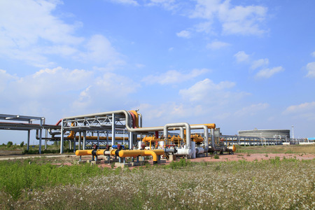 In oil field, there is oil pipeline and oilfield equipment at workの写真素材