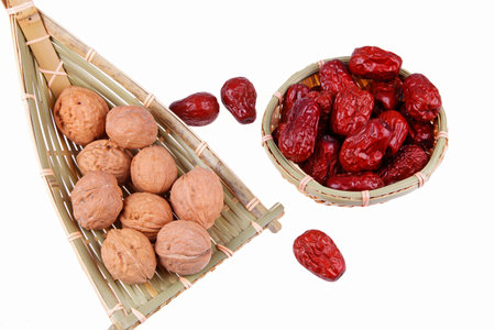 Walnuts and red jujube close-up, white backgroundの写真素材