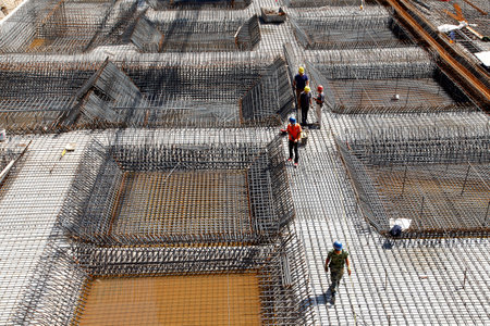 worker in the construction site making reinforcement metal framework for concrete pouringのeditorial素材