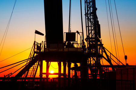 In the evening, the silhouette of oilfield derrick