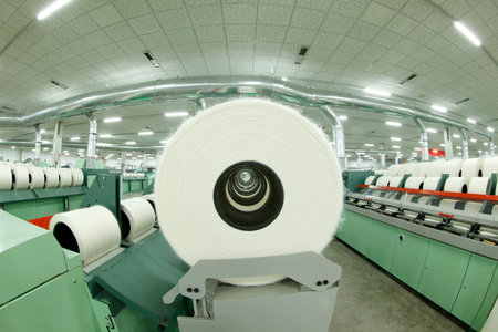 Spinning mill workshop, the workers operating Spinning equipment at work