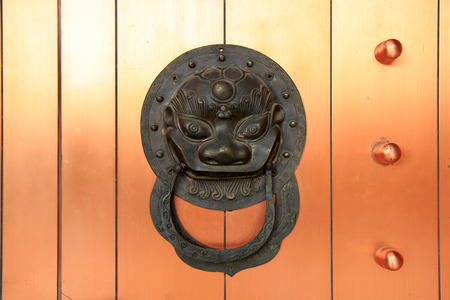 Ancient Chinese architecture copper door knocker Symbol propitious and majestyの写真素材