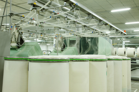 Spinning mill workshop, the workers operating Spinning equipment at workの写真素材