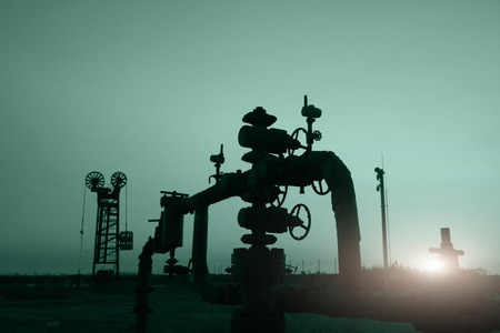 In the evening of oilfield pipeline silhouetteの写真素材