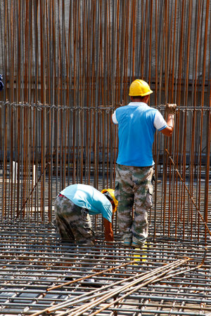 worker in the construction site making reinforcement metal framework for concrete pouringのeditorial素材