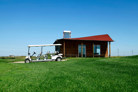 White golf carts at the green golf courseのeditorial素材