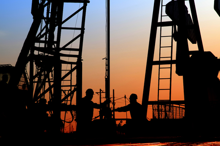 oil field, the oil workers are workingの写真素材
