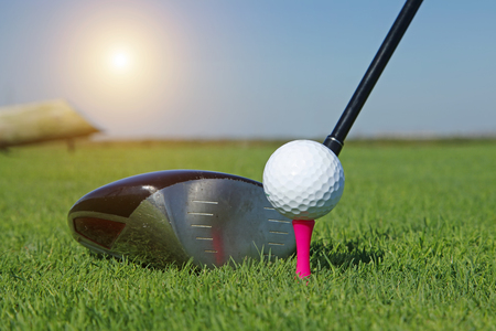 Golf club and ball in grassの写真素材