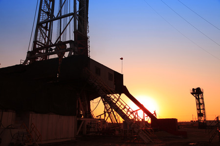The silhouette of oilfield derrickの写真素材