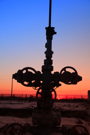 In the evening of oilfield pipeline silhouetteの写真素材