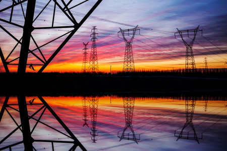 The silhouette of the evening electricity transmission pylon