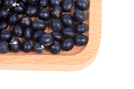 black beans on a wooden plate close up viewの写真素材